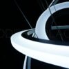 Large modern chandelier with LED lights and crystal teardrop details, nestled in a coffered ceiling.
