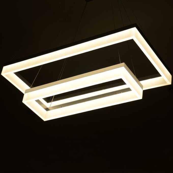 Modern geometric pendant lights with warm LED illumination.