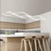 minimal-modern-3-wave-light-fixture Modern kitchen with stylish wave-design pendant lighting over island.