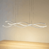 f737290f-7f39-42da-9c6e-9b595b88c226 Modern wavy LED pendant light fixture illuminating a wooden table in a minimalistic interior setting.