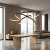 48f97e87-c5fd-4e95-971b-c72b6a2f8355 Modern dining room with sleek wooden table, abstract chandelier, and large windows for natural light.