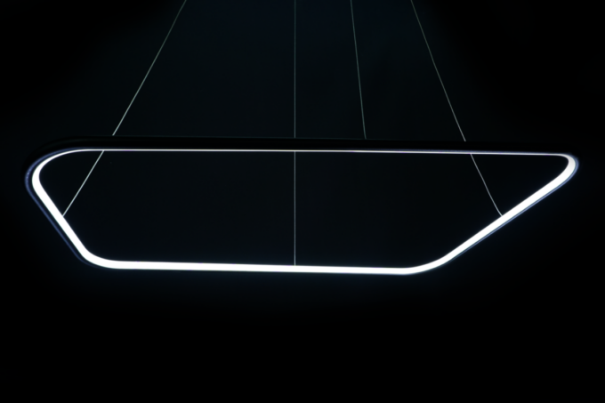 Modern LED pendant light with a minimalist design against a dark background.