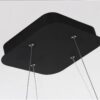 Stylish geometric chandelier light with warm glow in modern minimalist living room
