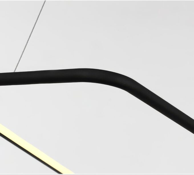 Close-up of black curved metal bar with contrasting white background