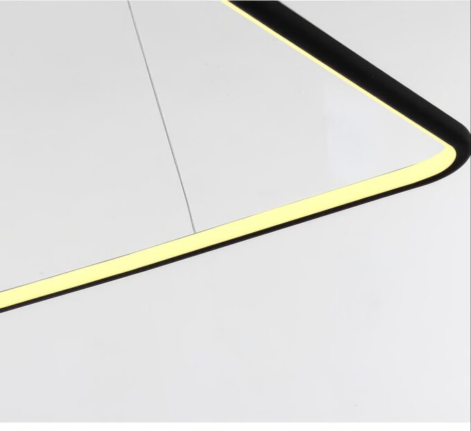 Contemporary circular chandelier hanging from high ceiling in a minimalist interior setting.