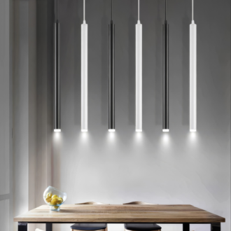 Modern pendant lights over wooden table in minimalist interior.