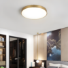 Modern bedroom interior with flush mount ceiling light and art decor.