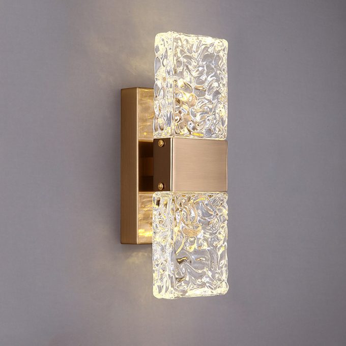 Modern gold wall sconce with illuminated textured glass shades