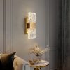 Elegant crystal wall sconce lighting in a modern living room setting.