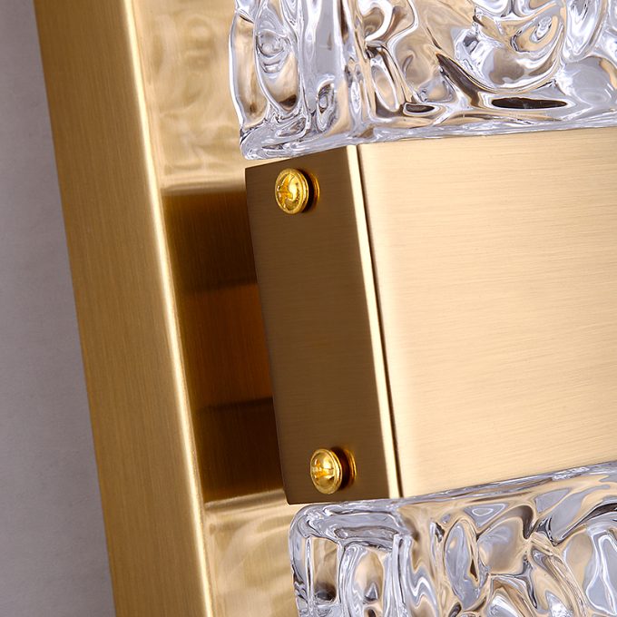 Close-up of gold frame mirror with intricate glass design.