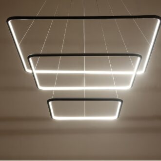 Modern LED pendant lights in geometric shapes hanging from ceiling.