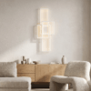 blocks_living_room_white Modern minimalist living room with abstract wall art, wooden sideboard, and neutral furniture.