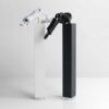 3 White and black design lamps shaped like knots on pedestals against a plain background.
