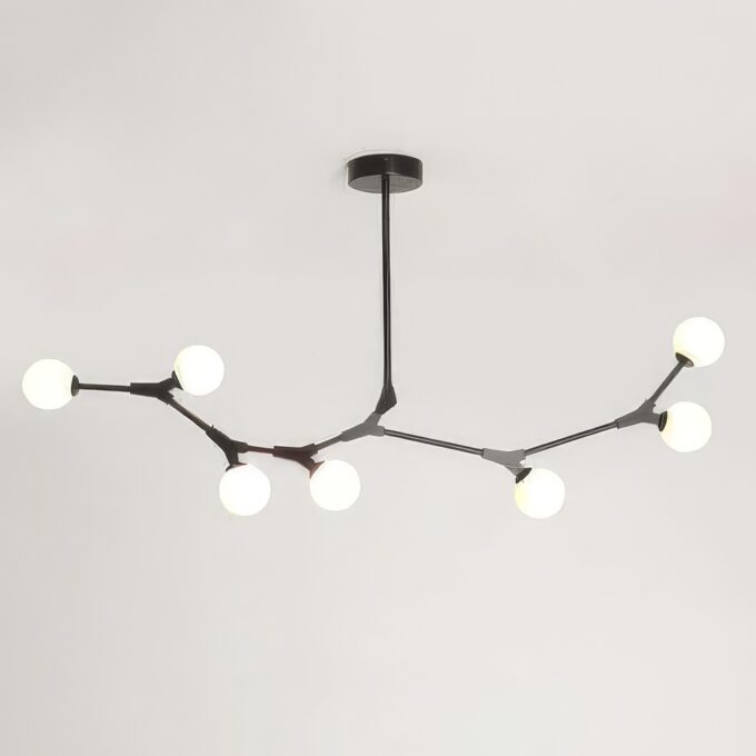 Modern branch-style chandelier with white globes on a gray background.