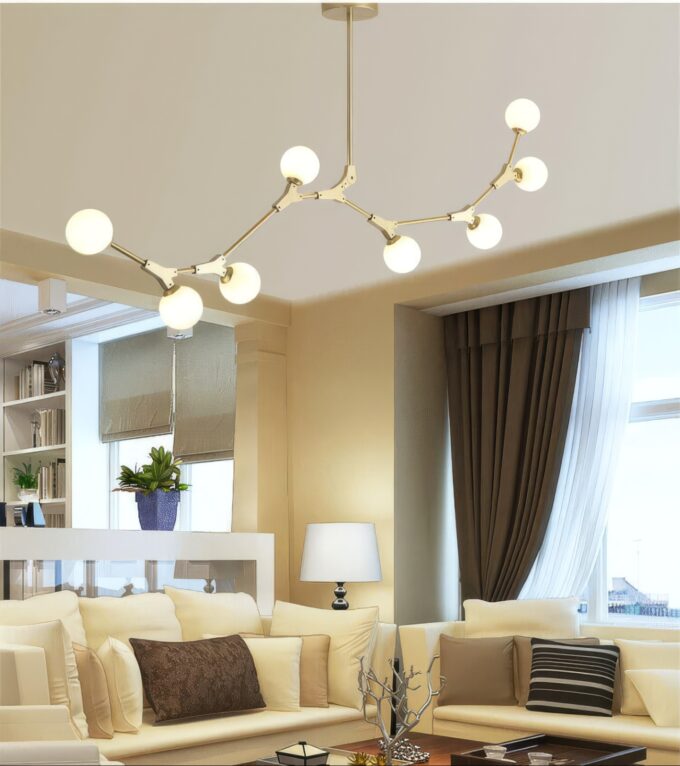 Modern living room with stylish spherical chandelier and cozy sofa.
