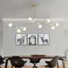 Contemporary black pendant light illuminating a spacious living room with neutral decor.