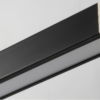 new-style-office-side-view Black picture frame edge with contrasting wood corner detail on a grey background.