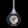 51F9MH4K46L._AC_SL1000_ Moon illusion in wine glass against black background, creative concept