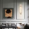 Elegant dining room with modern art and designer lighting fixture.