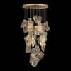 1 Modern gold pendant light with abstract shapes on black background.