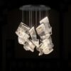 3 Modern mesh design chandelier lighting fixture in a dark room.