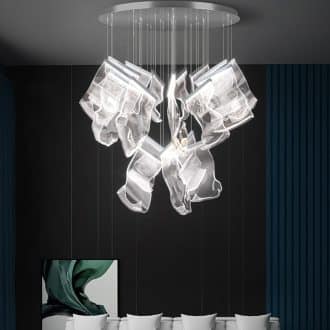 Modern glass chandelier in a contemporary room with white chairs.