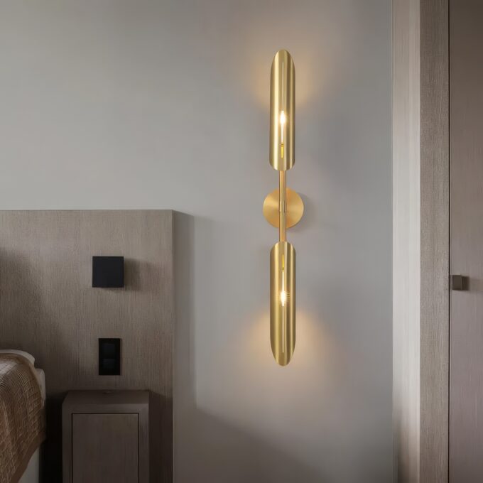 Modern gold wall sconce lighting in a contemporary bedroom setting.