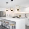 51l7EmyVLvL._AC_SL1000_ Modern white kitchen interior with gold pendant lights and bar stools.