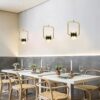 61uJzvQlgzL._AC_SL1000_ Modern dining room with elegant pendant lights and Scandinavian style decor.