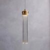 Elegant pendant light with brass accents against a grey backdrop.