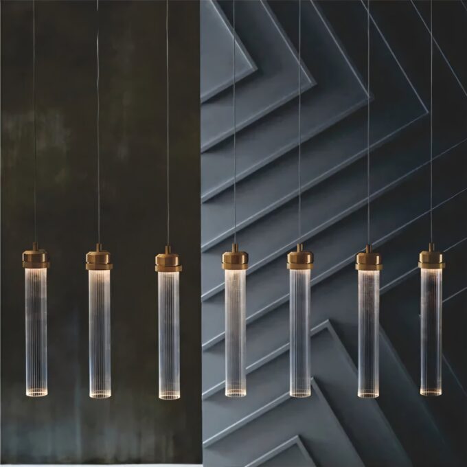Modern pendant lights with gold accents against dark background