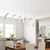 0d3906a1caaa0643bfbab3f3a0467479 Modern kitchen with unique loop pendant lights over wooden table.
