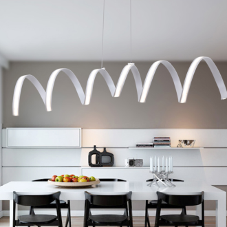 Modern white kitchen with stylish wave-shaped pendant lights over table.