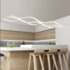 minimal-modern-3-wave-light-fixture Modern kitchen with stylish wave-design pendant lighting over island.