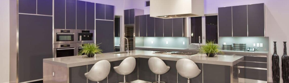 Modern kitchen with sleek design, island and bar stools.