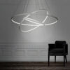 Modern circular LED pendant light above a black chair in an elegant room.