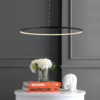 matte-black-jonathan-y-pendant-lights-jyl7220a-40_1000 (Custom) Sleek black modern pendant light over books, vase with flowers, and elephant figurine on white table against dark wall.