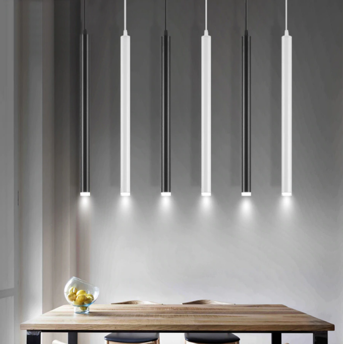 tube-cylindrical-pendant-led-light Modern pendant lights over wooden table in minimalist interior.