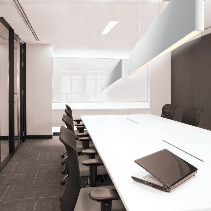 Modern black and white geometric kitchen with sleek design and minimalist lighting fixtures.