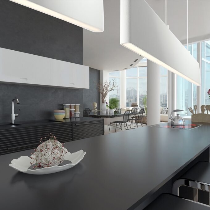 Modern kitchen interior with pendant lights and city view.