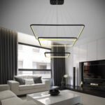 Modern white curvilinear pendant lamp hanging against a dark background