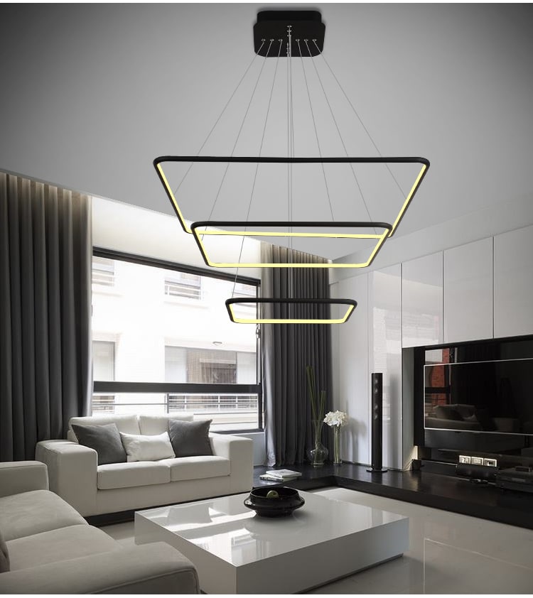 Modern white curvilinear pendant lamp hanging against a dark background