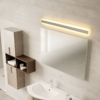 path-vanity-1_2x Modern bathroom with a lighted mirror, wooden cabinets, and a sleek white sink.