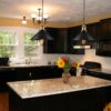 s-l1600 (4) Modern kitchen with black cabinets, granite countertops, and pendant lights.