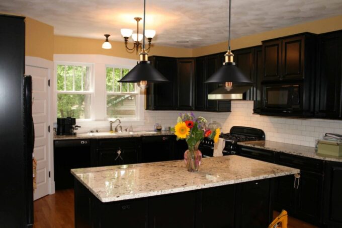 s-l1600 (4) Modern kitchen with black cabinets, granite countertops, and pendant lights.
