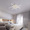 Modern bedroom with stylish ceiling light fixture and elegant decor.