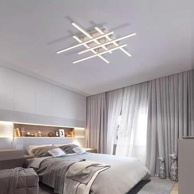Modern bedroom with stylish ceiling light fixture and elegant decor.