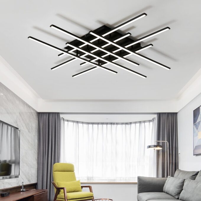 Modern living room with geometric ceiling light fixture and stylish furniture.