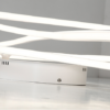 c22f404adf0116cf66e40ff7f4004584 Modern LED light fixture with sleek design on a white background.
