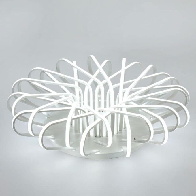 Modern white LED ceiling light with abstract loop design on a grey background.